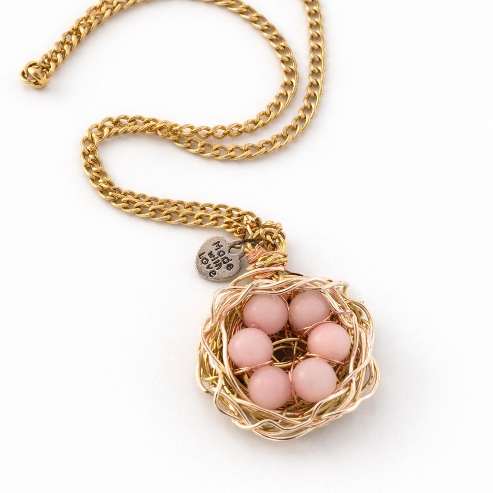 GOLD TONE Bird Nest Necklace with pink opal eggs and crystal accents.